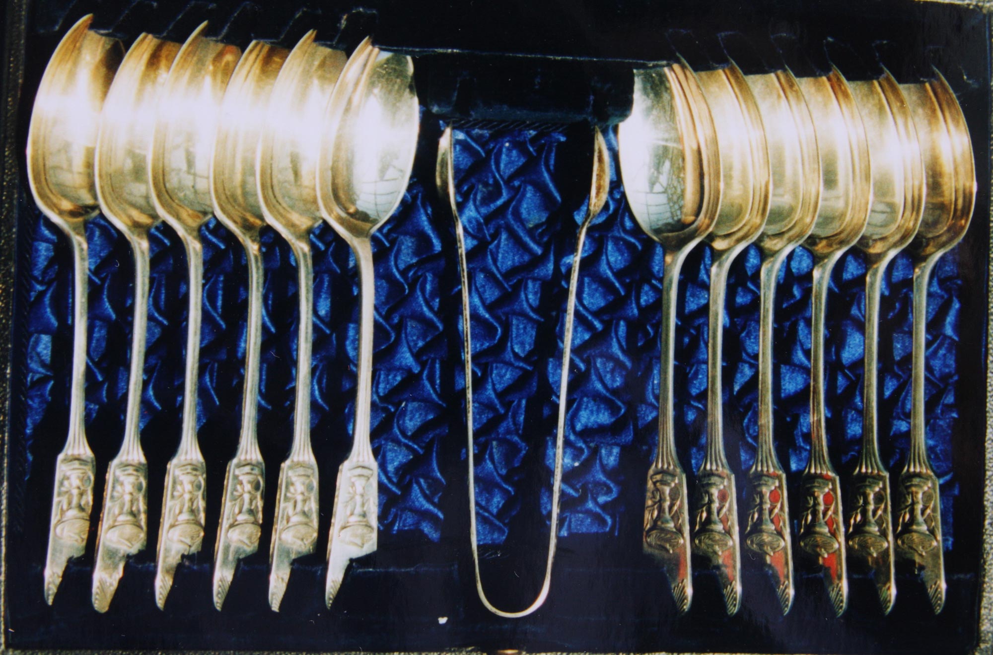 A handsome case of best quality Electro Plated Tea Spoons and Tongs value 21/-