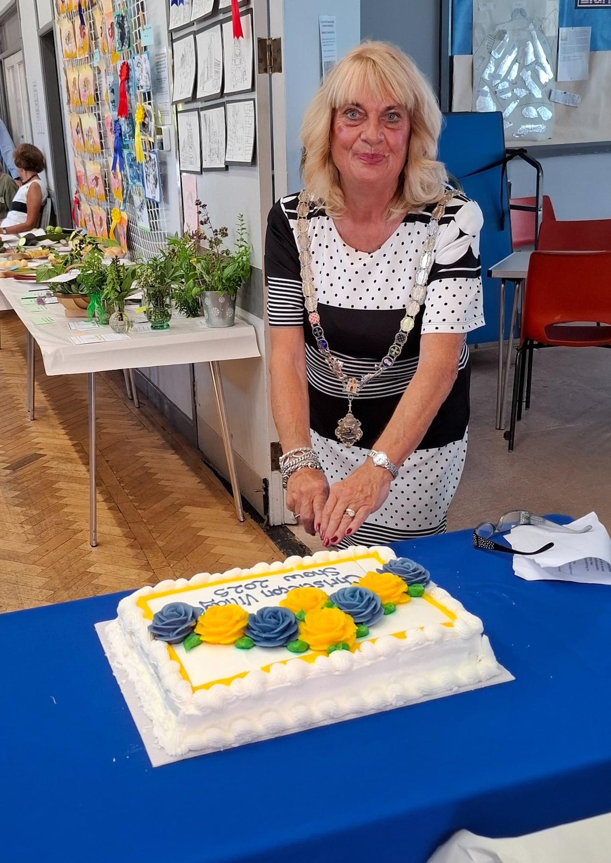 Mrs Margaret Parker cutting Christleton Village Show Cake 2025