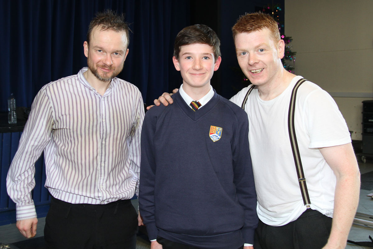 Two memebers of the company with a student  Two memebers of the company with a student